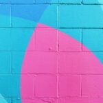 closeup photo of teal and pink wall